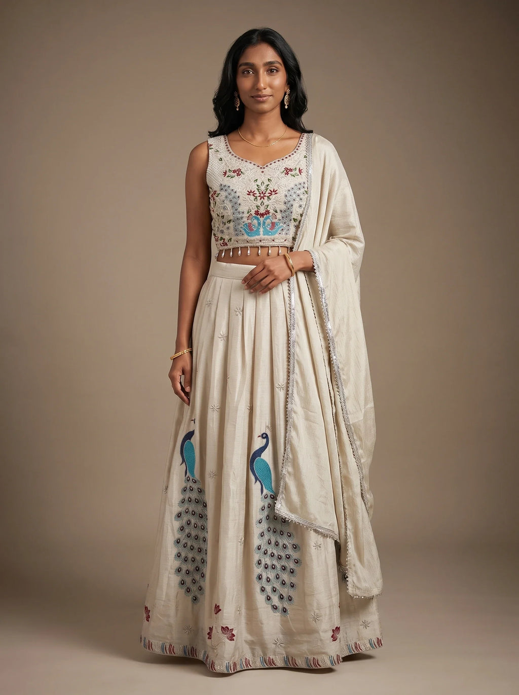 Model wearing a pearl grey georgette lehenga set with embroidered peacock motifs and matching dupatta