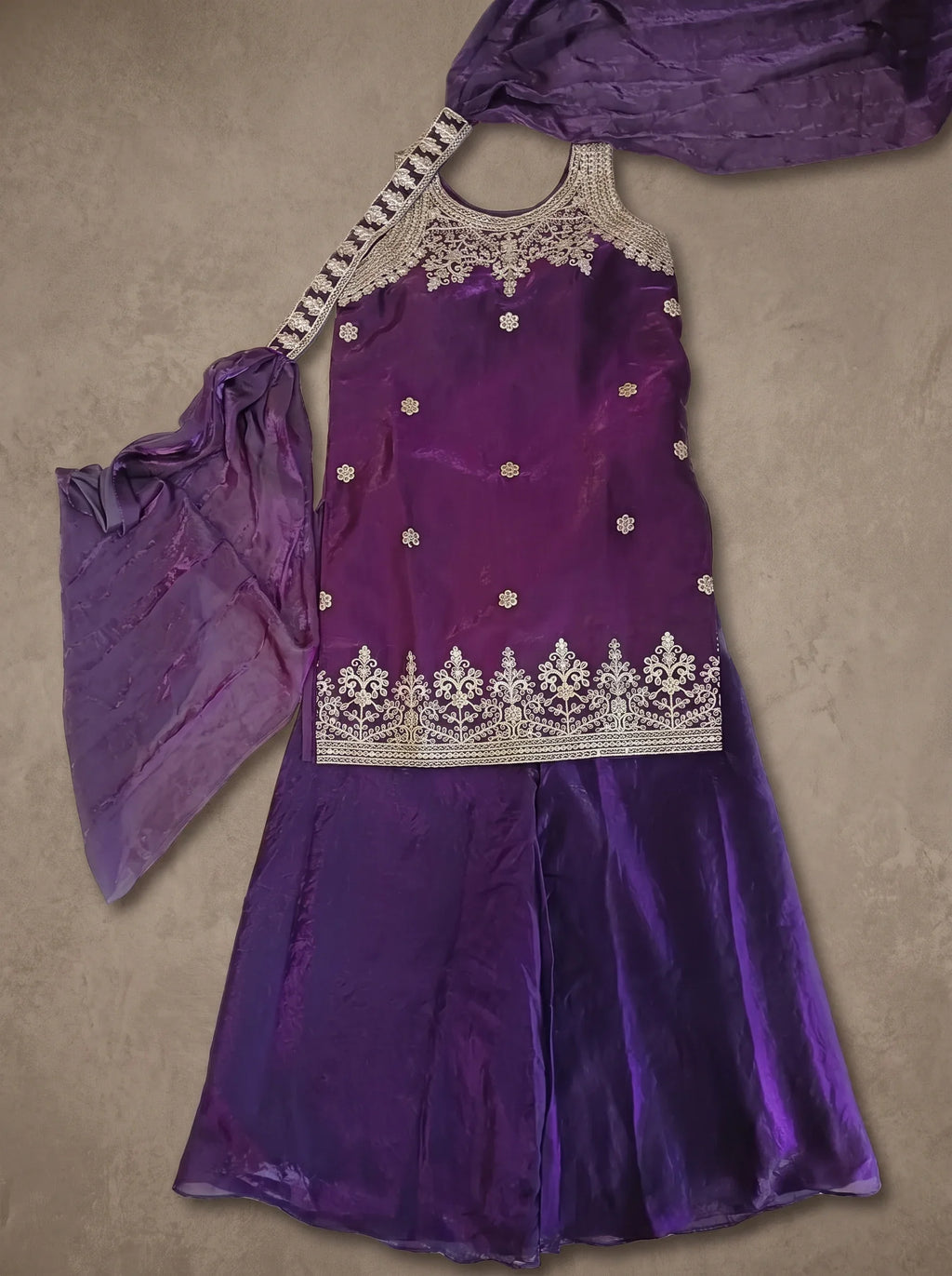 Violet tissue silk embroidered sharara set with matching dupatta displayed flat
