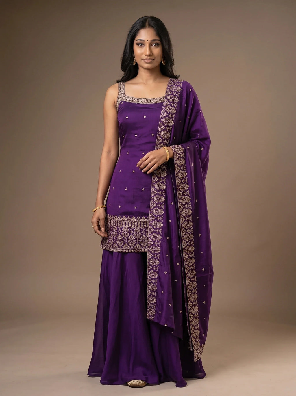 Model wearing a violet georgette sharara set with sequin embroidery and matching bordered dupatta