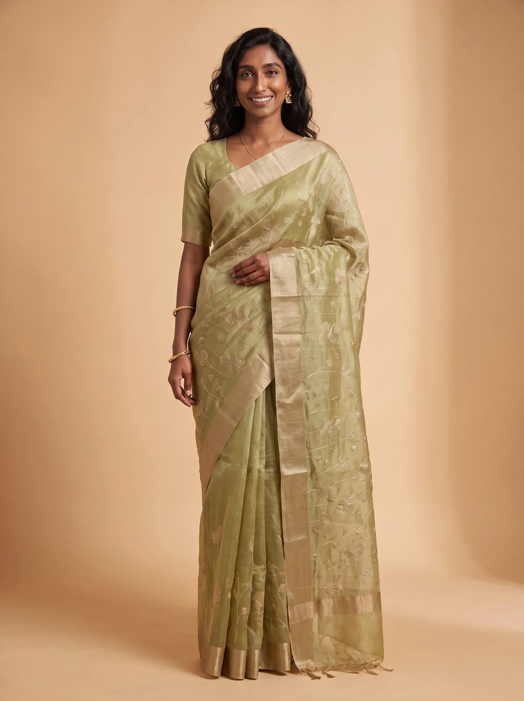 Model wearing pista green ready-to-wear kota tissue saree with floral zari embroidery and contrasting border