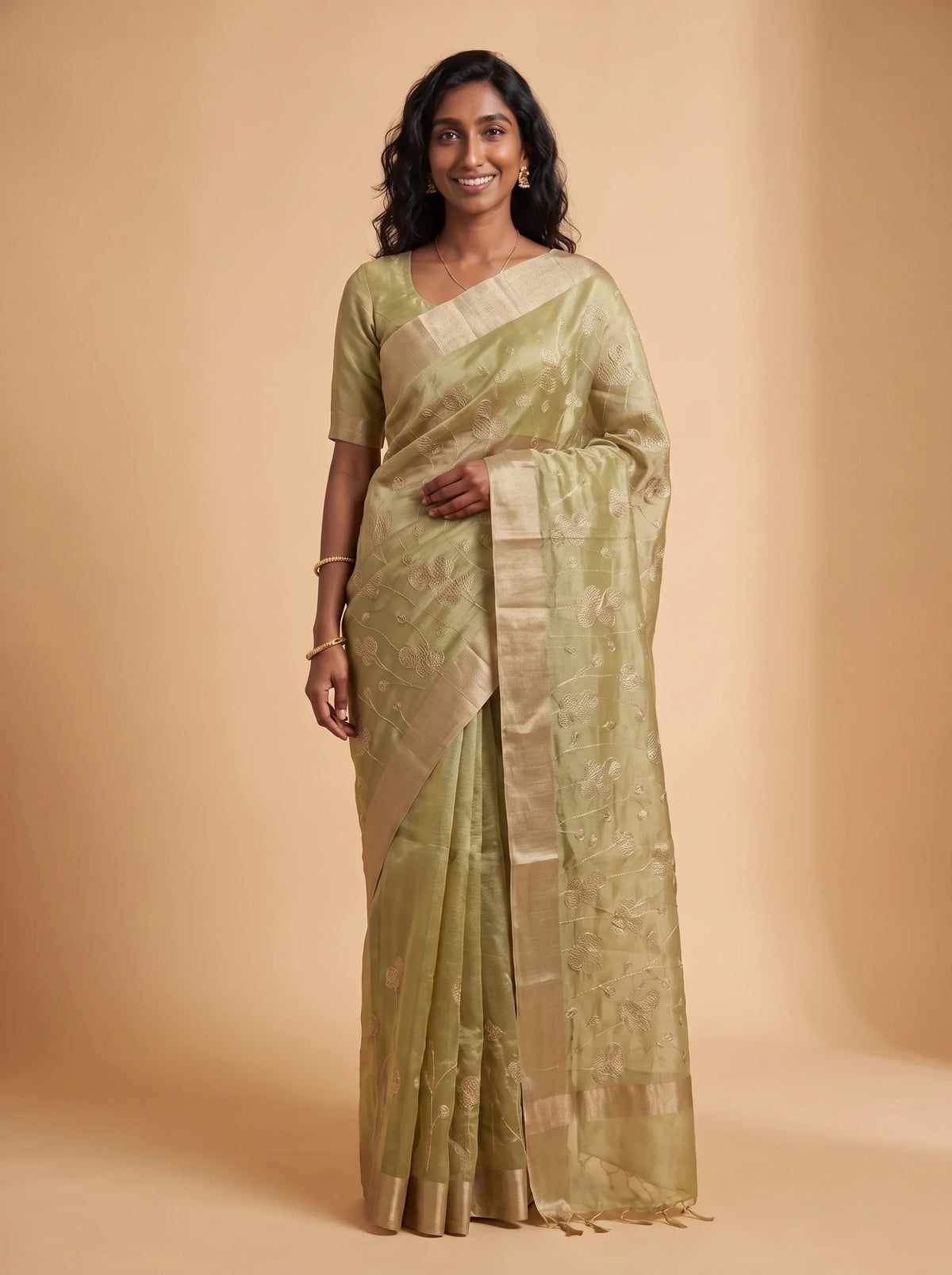 Model wearing pista green ready-to-wear kota tissue saree with floral zari embroidery and contrasting border