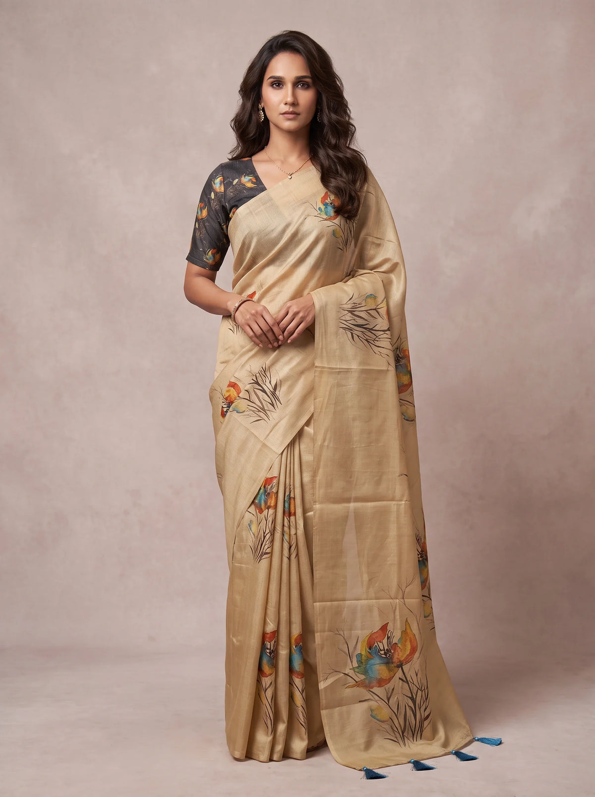 Model wearing a beige linen floral printed saree with blue tassels at the pallu
