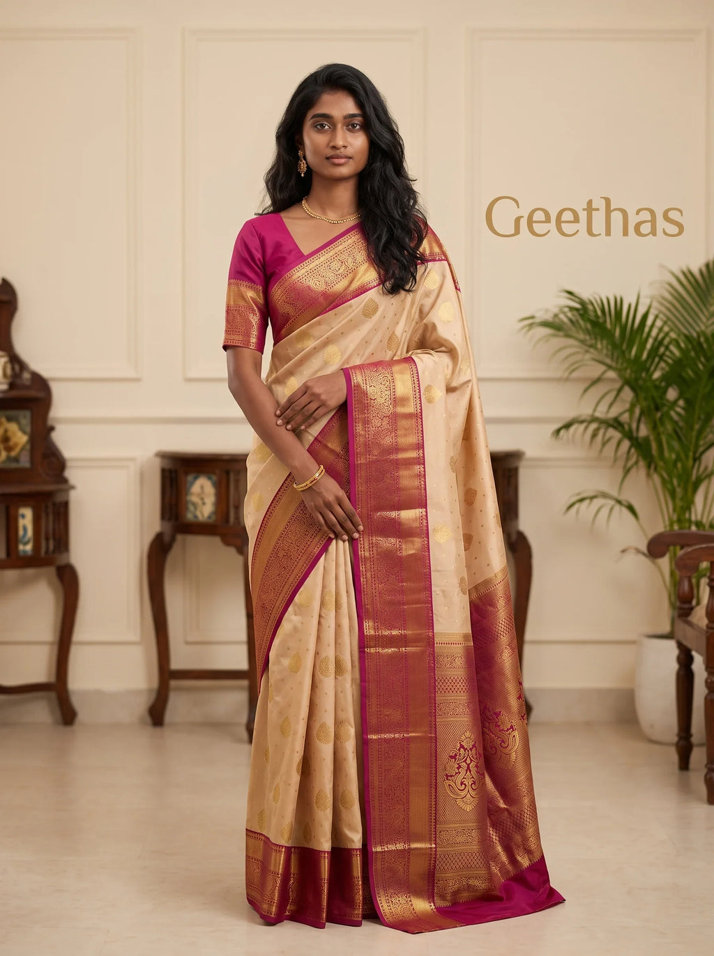 Model wearing a light peach soft silk saree with gold-toned motifs and a magenta zari border