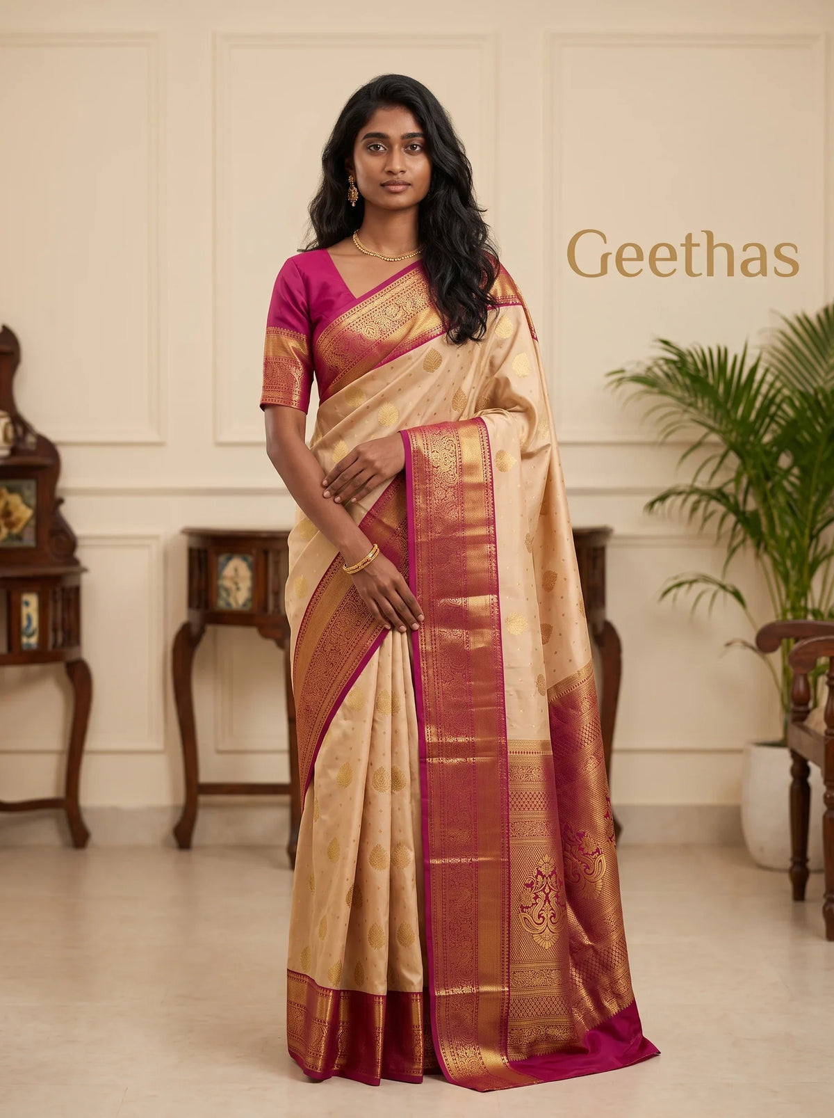 Model wearing a light peach soft silk saree with gold-toned motifs and a magenta zari border