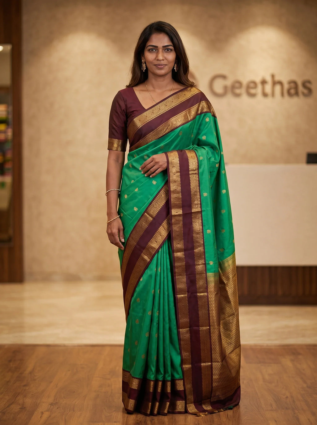 Model wearing bottle green soft silk saree with a deep maroon patterned border and pallu