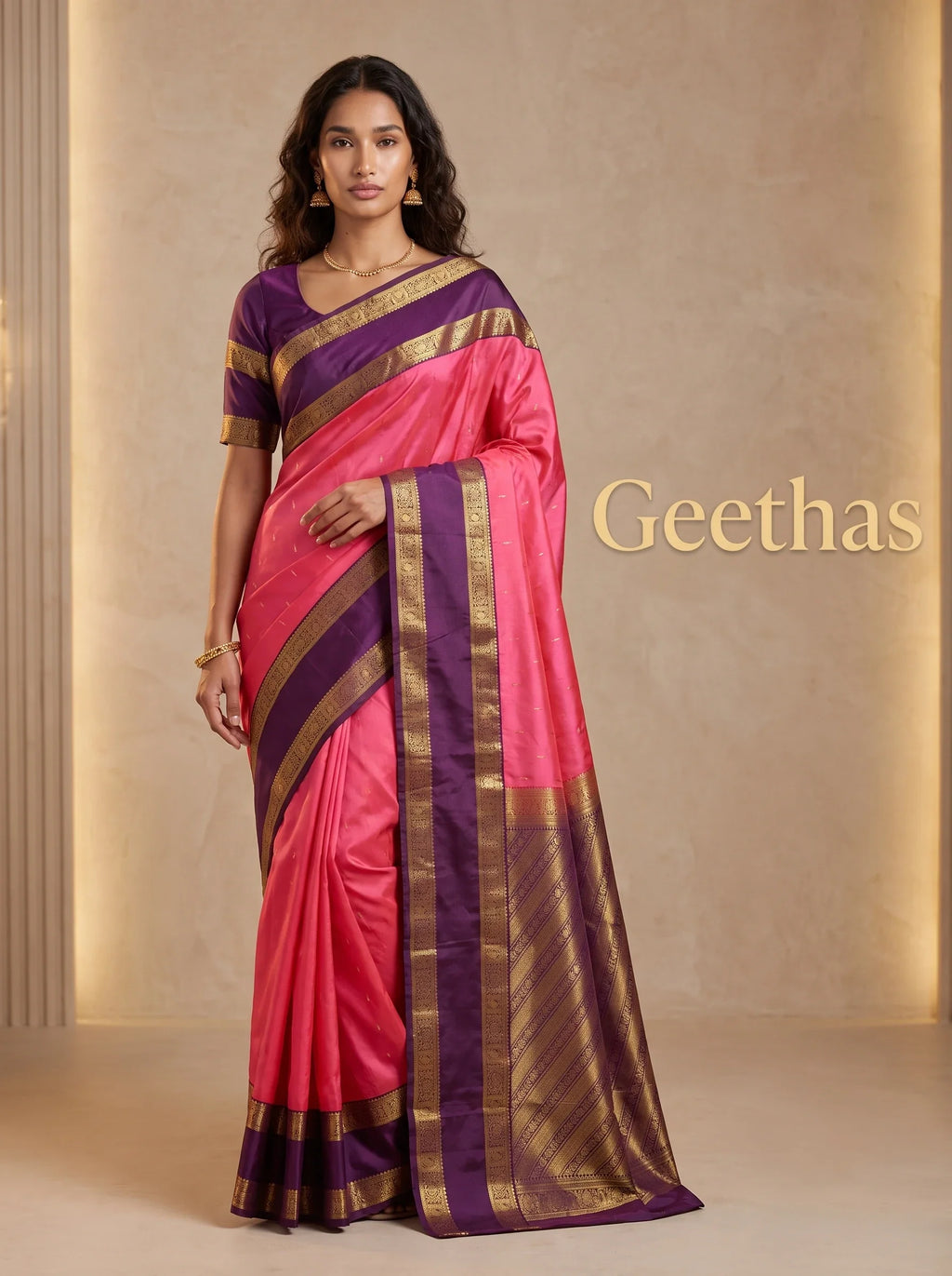 Model wearing a vibrant pink soft silk saree with deep purple pallu and intricate gold-toned woven border